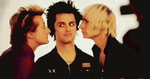 three men are standing next to each other and one of them has the letter xx on his shirt