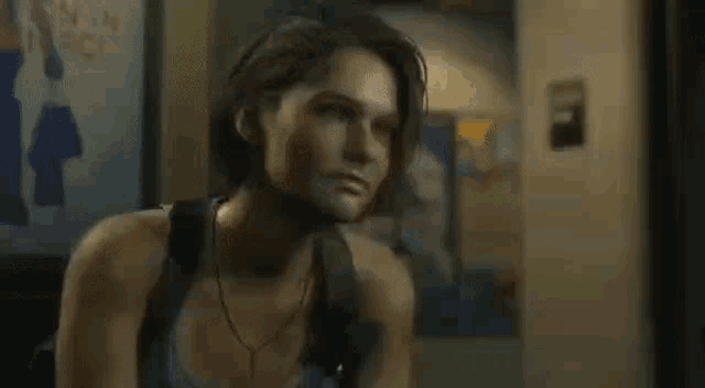 a woman with short hair is standing in front of a sign in a dark room .