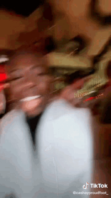 a blurry picture of a person 's face with a tiktok watermark
