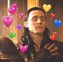 a man with his eyes closed is surrounded by hearts on his face .