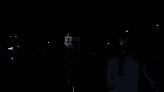 a blurred image of a person standing in the dark