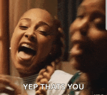 two women are laughing with their tongues out and one of them is saying yep that 's you .