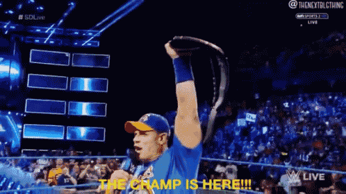 a man in a blue shirt is holding a trophy in his hand and says the champ is here