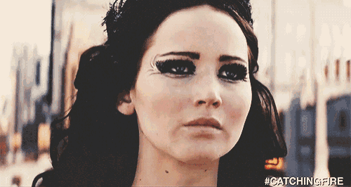 a close up of a woman 's face with the hashtag #catchingfire on it
