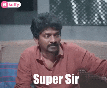 a man with a mustache is sitting on a couch with the words `` super sir '' written on his face .