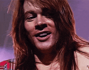 a close up of a man 's face with a purple background and a x on it