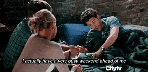 a group of people are sitting on a bed and one of them is saying i actually have a very busy weekend ahead