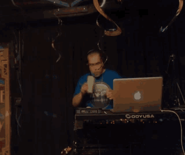 a man wearing headphones sits in front of an oddy usa keyboard