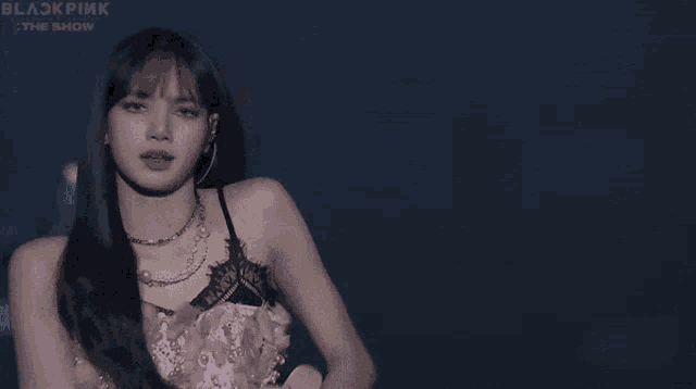 blackpink performing on stage at the show with a blue background