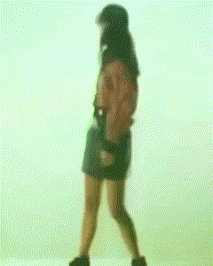 a woman in a short skirt is walking in front of a white background