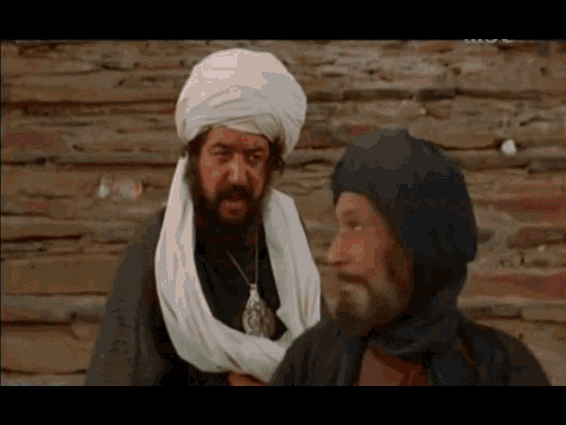 two men are standing next to each other and one has a beard