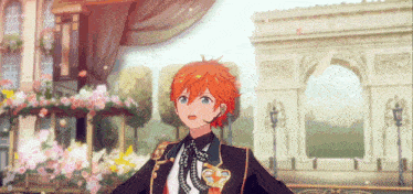 a boy with red hair is standing in front of a building with flowers on it .