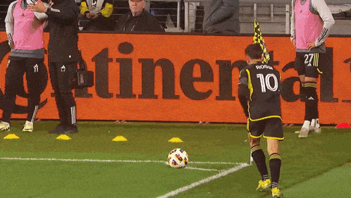 a soccer game is being played in front of a sign that says adidas