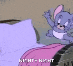 a cartoon character is laying on a bed with a pink blanket on .