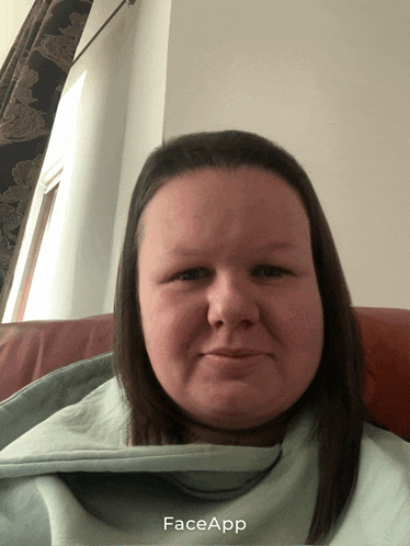 a woman laying on a couch with a face app app on the bottom