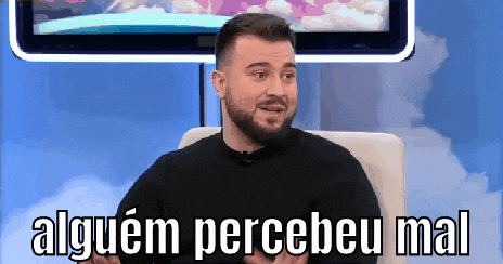 a man with a beard is sitting in front of a television with the words alguem percebeu mal on the screen