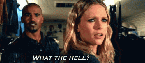 a man and a woman are standing in a room and the woman is asking what the hell