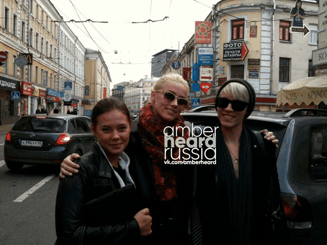 three women posing for a picture with the words amber heard russia