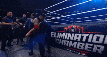 a wrestling ring with a sign that says elimination chamber on it