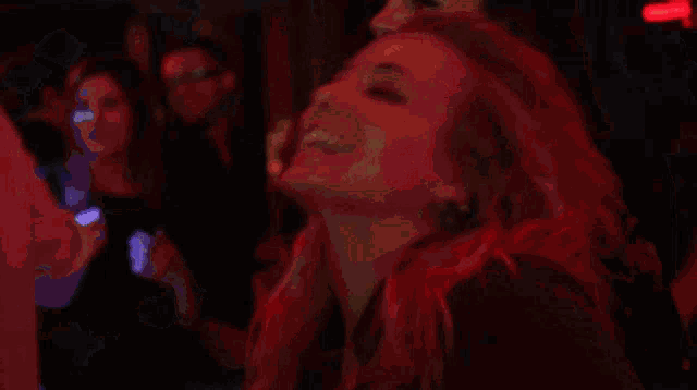a blurry picture of a crowd of people dancing in a club
