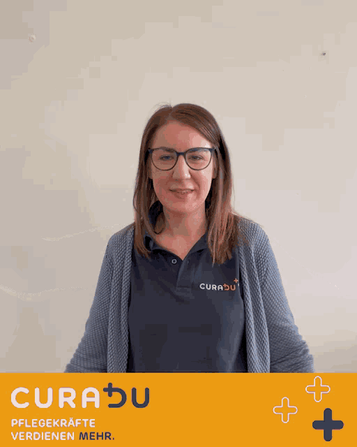a woman wearing glasses and a curadu shirt