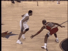 a basketball player with the number 23 on his jersey is dribbling the ball