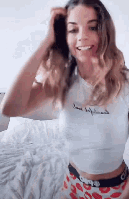 a woman wearing a white shirt with the word girlfriend on it