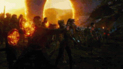 a group of people are standing in front of a large fireball .