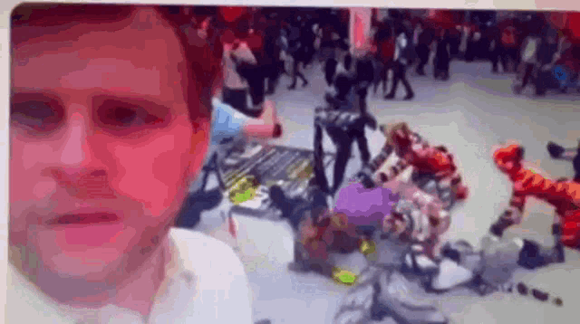 a man in a white shirt is standing in front of a crowd of people
