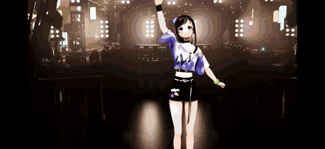 a girl in a blue shirt is standing on a stage with her hand in the air