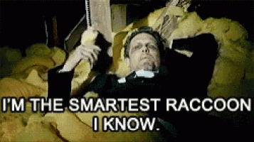 a man in a suit is laying in a pile of foam holding a book and a phone .