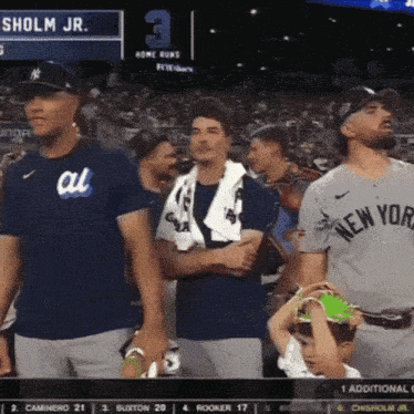 a man wearing a new york jersey stands in front of a crowd
