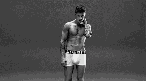 a man is wearing a pair of calvin klein underwear with a black band around his waist .