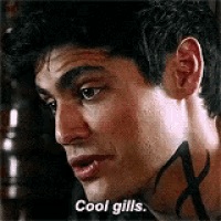 a close up of a man 's face with the words `` cool gills '' written on his face .