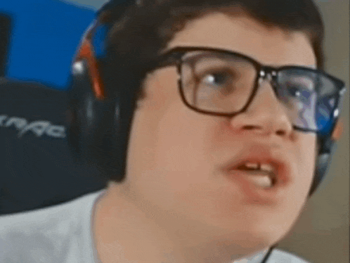 a young boy wearing glasses and headphones is making a face .