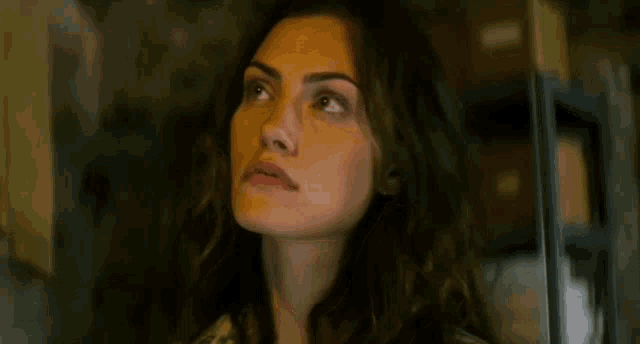 a close up of a woman 's face with a blurred background .