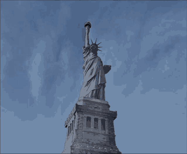 the statue of liberty against a blue sky with clouds