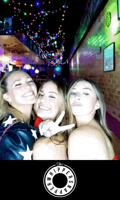 three women posing for a picture with a logo that says " the whippersnappers "