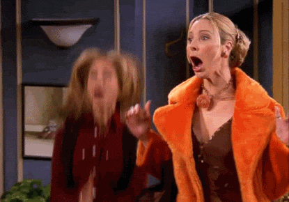 two women are standing next to each other with their mouths open .