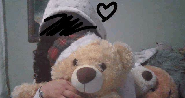 a person holding a teddy bear with a drawing of a heart behind them