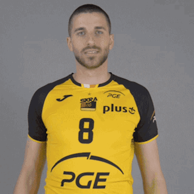 a man wearing a yellow and black pge jersey