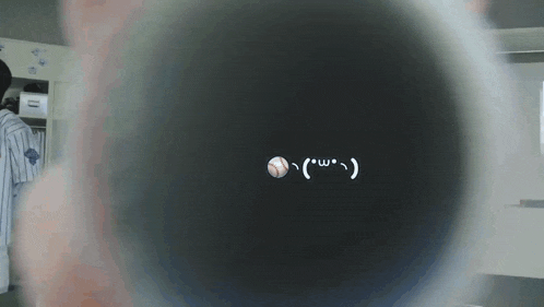 a baseball with a smiley face on it is visible in the dark