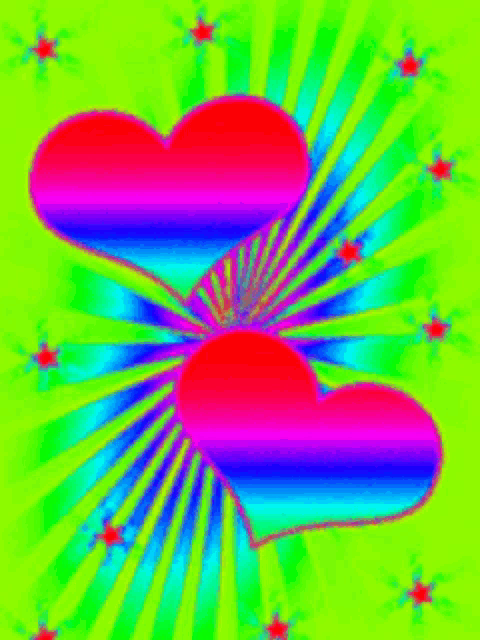 two colorful hearts are on a green background