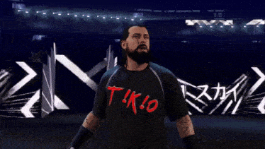 a man with a beard is wearing a shirt that says t!k!