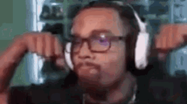 a man wearing headphones is making a funny face .