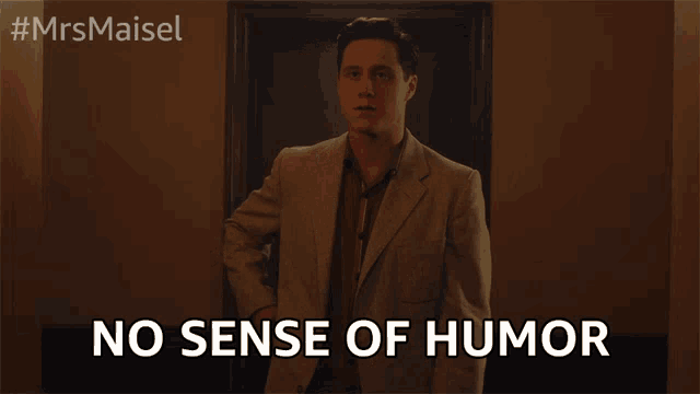 a man in a suit says " no sense of humor " in front of a door