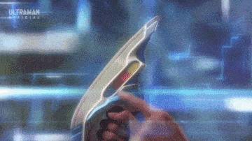 a person is holding a futuristic device in their hand in front of a screen .