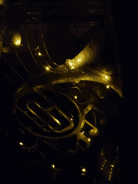 a volkswagen logo is lit up in the dark with string lights