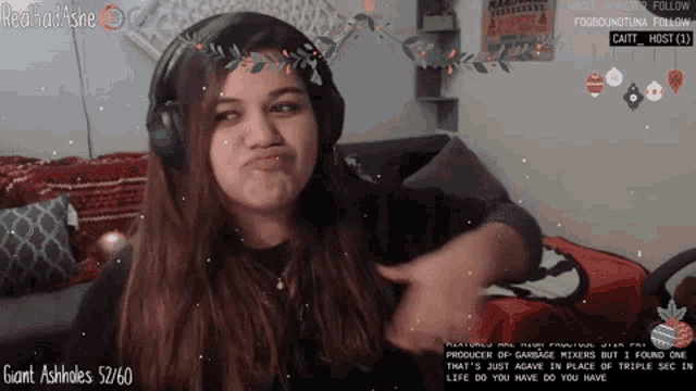 a woman wearing headphones with giant ashholes 52/60 in the lower right corner