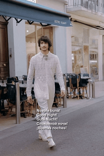 a man walking down a street in front of a building that says bistro vivianct